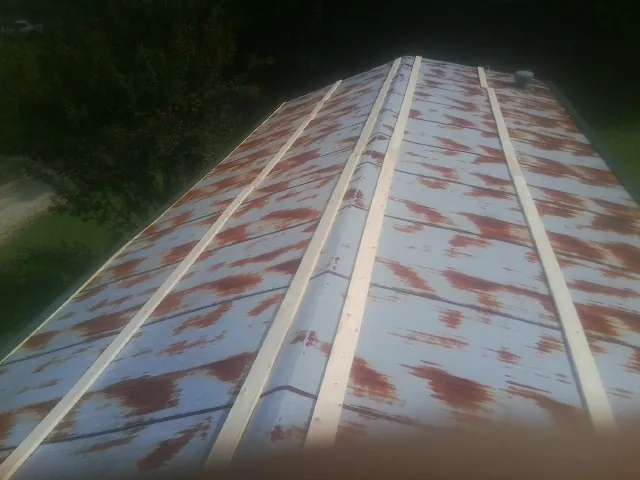 Rusted metal roof panels with new wood purlins before replacement — Storm Damage Roof Repair in Turlock by Roofing Brothers